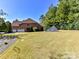 View of the backyard featuring a large lawn and the rear of the home at 16506 Doves Canyon Ln, Charlotte, NC 28278