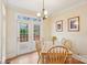 Cozy dining room with neutral walls, light wood furniture and access to patio at 16506 Doves Canyon Ln, Charlotte, NC 28278