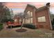 Brick home with large windows and a spacious deck in a landscaped backyard at 16506 Doves Canyon Ln, Charlotte, NC 28278