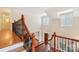 View from the landing of the foyer with a staircase and wood front door at 16506 Doves Canyon Ln, Charlotte, NC 28278
