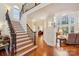 Elegant foyer with a staircase, wood floors, and living area at 16506 Doves Canyon Ln, Charlotte, NC 28278