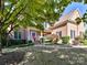 Brick two story home with covered entry and professionally landscaped yard at 16506 Doves Canyon Ln, Charlotte, NC 28278
