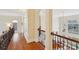 Upstairs hallway with dark hardwood floors and arches to the main living area at 16506 Doves Canyon Ln, Charlotte, NC 28278