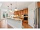 Well-lit kitchen features granite countertops, stainless steel appliances and custom cabinets at 16506 Doves Canyon Ln, Charlotte, NC 28278