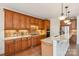 Kitchen with stainless steel appliances, custom cabinets, tile backsplash and flooring at 16506 Doves Canyon Ln, Charlotte, NC 28278