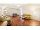 Upstairs bonus room with three sofas, a glass coffee table, and hardwood flooring at 16506 Doves Canyon Ln, Charlotte, NC 28278