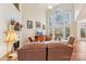 Bright living room features high ceilings, large windows, fireplace, and comfortable seating at 16506 Doves Canyon Ln, Charlotte, NC 28278