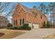 Brick home with a three car garage and paved driveway at 16506 Doves Canyon Ln, Charlotte, NC 28278