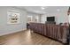 Bright living room with hardwood floors, abundant natural light, and a comfortable brown sofa at 17215 Monocacy Blvd, Huntersville, NC 28078