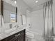 Clean bathroom with vanity, tub/shower, and natural light with lake view at 18302 Town Harbour Rd, Cornelius, NC 28031