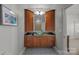 Stylish bathroom featuring wood cabinetry, granite countertop, and clear glass sink at 18302 Town Harbour Rd, Cornelius, NC 28031