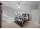 Neutral bedroom featuring a checkered bedspread and adjoining bath at 18302 Town Harbour Rd, Cornelius, NC 28031
