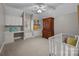 Comfortable bedroom featuring built-in shelving, desk area, and a cozy crib at 18302 Town Harbour Rd, Cornelius, NC 28031