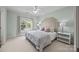 Serene bedroom with soft colors, large window, and stylish bed with upholstered headboard at 18302 Town Harbour Rd, Cornelius, NC 28031