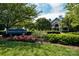 Beautiful community clubhouse with manicured landscaping and vibrant flowerbeds at 18302 Town Harbour Rd, Cornelius, NC 28031