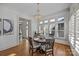 Cozy dining room with wood floors, shuttered windows, and a stylish chandelier at 18302 Town Harbour Rd, Cornelius, NC 28031