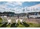 Inviting Adirondack chairs on a wooden dock overlooking a tranquil harbor with numerous sailboats at 18302 Town Harbour Rd, Cornelius, NC 28031