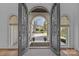 Grand entrance foyer with wrought iron doors leading into the home at 18302 Town Harbour Rd, Cornelius, NC 28031