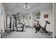 Home gym filled with workout equipment, mirrors, and a wall-mounted television for entertainment at 18302 Town Harbour Rd, Cornelius, NC 28031