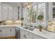 Bright kitchen features custom cabinets, marble countertops, stainless appliances, and mosaic tile backsplash at 18302 Town Harbour Rd, Cornelius, NC 28031