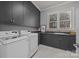 Well-equipped laundry room featuring ample storage and counter space with appliances included at 18302 Town Harbour Rd, Cornelius, NC 28031
