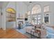 Spacious living room featuring high ceilings, a fireplace, and scenic lake views at 18302 Town Harbour Rd, Cornelius, NC 28031
