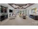 Open-concept living room features a fireplace, media center, and access to the outdoor patio at 18302 Town Harbour Rd, Cornelius, NC 28031
