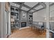 Home office with custom built-ins, a fireplace, and hardwood floors at 18302 Town Harbour Rd, Cornelius, NC 28031