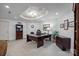 Well-lit home office with a large desk, comfortable chair, and built-in shelving at 18302 Town Harbour Rd, Cornelius, NC 28031