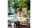Outdoor table set with glasses of water, lemonade, and lemons, offering a relaxing view of the lake at 18302 Town Harbour Rd, Cornelius, NC 28031