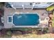 Aerial view of a large backyard pool with a hot tub, fire pit, and lounge chairs for relaxation at 18302 Town Harbour Rd, Cornelius, NC 28031