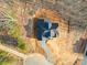 Top down aerial view of a gray brick home featuring a paved driveway and an unfinished yard at 240 Mark Ryan Ln, Dallas, NC 28034