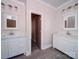 Bright bathroom with dual vanities featuring white cabinets, mirrors, modern fixtures and tile floors at 240 Mark Ryan Ln, Dallas, NC 28034