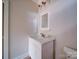 Bathroom with marble countertop, white cabinets and a light fixture at 240 Mark Ryan Ln, Dallas, NC 28034