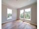 Bright bedroom featuring hardwood floors, three large windows and neutral wall color at 240 Mark Ryan Ln, Dallas, NC 28034