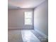 Bedroom features carpet, base trim, and bright window providing plenty of natural light at 240 Mark Ryan Ln, Dallas, NC 28034