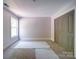Bedroom boasts neutral colors, base trim, carpet, closet and a window providing natural light at 240 Mark Ryan Ln, Dallas, NC 28034