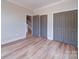 Bedroom with light walls, wood floors, closet and access to the stairway at 240 Mark Ryan Ln, Dallas, NC 28034
