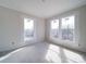 Bright bedroom featuring three windows providing natural light, crown moulding, and neutral walls at 240 Mark Ryan Ln, Dallas, NC 28034