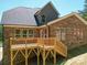 Brick home with a new deck, dark roof, and lush green landscaping, ready for outdoor living at 240 Mark Ryan Ln, Dallas, NC 28034