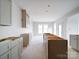 Spacious kitchen with unfinished cabinets provides a modern design, awaiting your personal touches for culinary paradise at 240 Mark Ryan Ln, Dallas, NC 28034