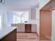 Bright kitchen features stainless steel appliances, white cabinets and light wood flooring at 240 Mark Ryan Ln, Dallas, NC 28034