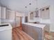 Open concept kitchen with shaker cabinets, stainless appliances and a spacious center island at 240 Mark Ryan Ln, Dallas, NC 28034