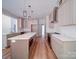 Bright kitchen features stainless steel appliances, white cabinets and light wood flooring at 240 Mark Ryan Ln, Dallas, NC 28034