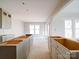 Bright new kitchen with unfinished cabinets and a kitchen island ready for countertops at 240 Mark Ryan Ln, Dallas, NC 28034