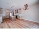 Open kitchen and dining area featuring hardwood floors, an island, and modern light fixtures at 240 Mark Ryan Ln, Dallas, NC 28034