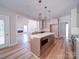 Open kitchen features a large island with seating, fireplace and lots of natural light at 240 Mark Ryan Ln, Dallas, NC 28034