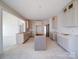 Bright new kitchen with unfinished cabinets and a kitchen island ready for countertops at 240 Mark Ryan Ln, Dallas, NC 28034