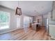 Open kitchen and dining area featuring hardwood floors, an island, and modern light fixtures at 240 Mark Ryan Ln, Dallas, NC 28034