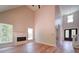 Bright living room featuring hardwood floors, a fireplace, high ceilings, and decorative front door at 240 Mark Ryan Ln, Dallas, NC 28034